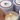 Lucette+Mo Daydream 6oz Travel Candle – soft floral candle tin with marigold, vanilla, and cedar shown being lit