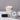 Lucette+Mo Hideaway 2oz Travel Candle – tropical travel candle with vanilla, cardamom, and citrus shown with matches