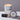 : Lucette+Mo Hideaway 6oz Travel Candle – tropical vanilla and citrus tin candle with soft spice shown with matches